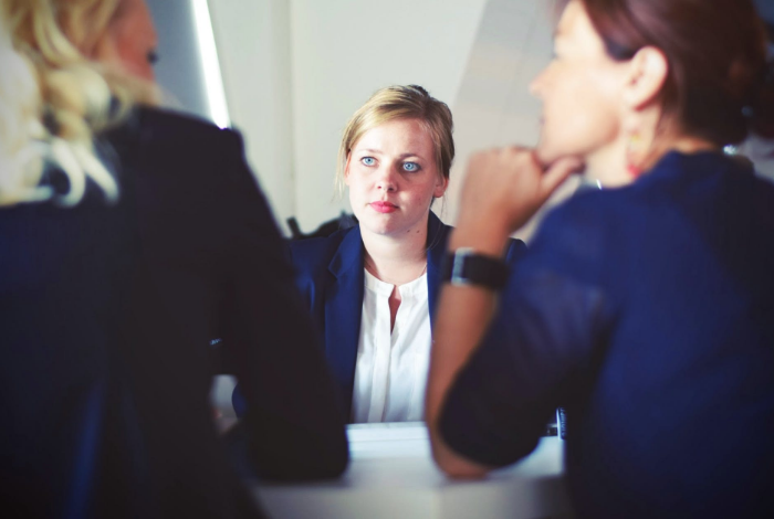 three people having a meeting indoors